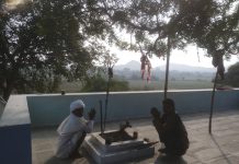 A devotee posing with the Dalit priest at the Chamunda Temple at Thana village, Bhilwara