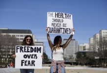 A group gathers to protest against social isolation rules of the COVID-19 pandemic, in Edmonton, Alta., on April 29, 2020.THE CANADIAN PRESS/Jason Franson