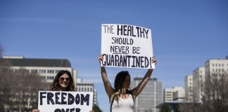 A group gathers to protest against social isolation rules of the COVID-19 pandemic, in Edmonton, Alta., on April 29, 2020.THE CANADIAN PRESS/Jason Franson