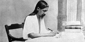 Sri Aurobindo (born Aurobindo Ghose) engrossed in writing. (Source: Wikimedia Commons)