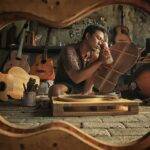 A man furnishing musical instruments at a workshop/ Pixabay