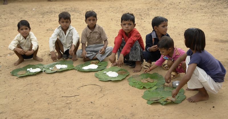 Children_eating_kheer_and_puri,_Chambal,_India