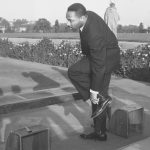 Rev. Martin Luther King Jr. removes his shoes before entering Mahatma Gandhi’s shrine in New Delhi, India, on Feb. 11, 1959. AP Photo