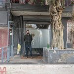 An ED official standing outside the Newsclick office in New Delhi