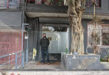 An ED official standing outside the Newsclick office in New Delhi