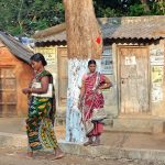 Tribal women from Odisha standing on the roadside.