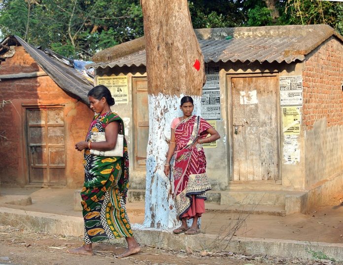 Tribal women from Odisha standing on the roadside.