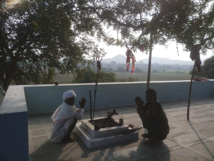 A devotee posing with the Dalit priest at the Chamunda Temple at Thana village, Bhilwara
