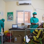 A healthcare worker performs a nasal swab as he tests a woman for COVID-19 in Bamako, Mali. Annie Risemberg/AFP via Getty Images